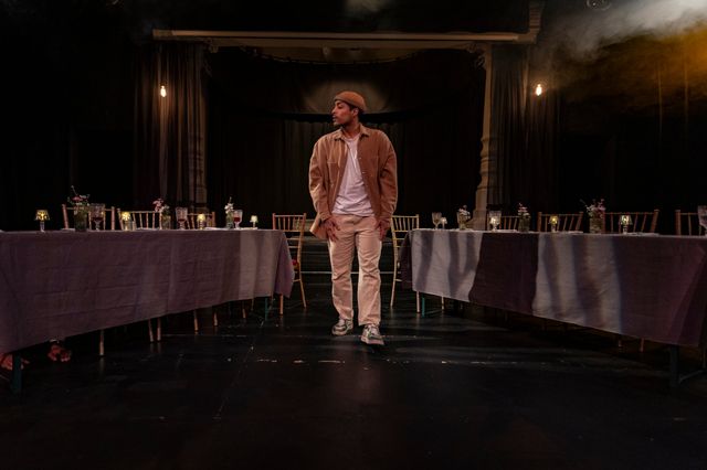 A lone figure between the long banquet tables